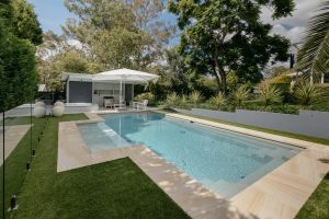 Compass Pools Australia Contemporary pool with a bench and beach attached 1