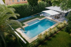Compass Pools Australia Contemporary pool with a bench and beach attached aerial